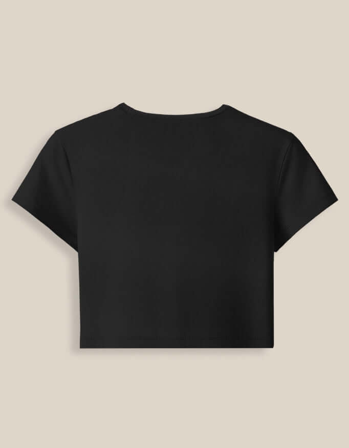 Back view of the Heartless Baby Tee showcasing its cropped design and soft black fabric.